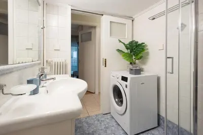 a bathroom with a sink and a washing machine at Blue Ark Exploring Athens in Athens
