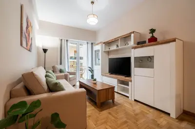 a living room with a couch and a tv at Rovertou Galli 3-5 by Athens Concept Residences in Athens