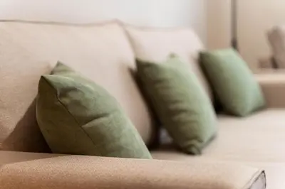 a couch with four green pillows on it at Rovertou Galli 3-5 by Athens Concept Residences in Athens