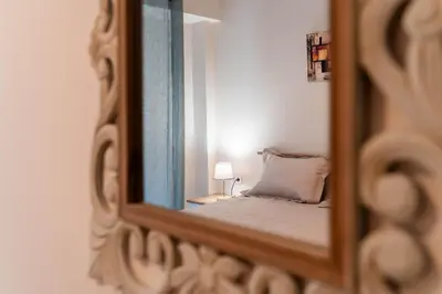 a mirror reflection of a bed in a bedroom at Rovertou Galli 3-5 by Athens Concept Residences in Athens