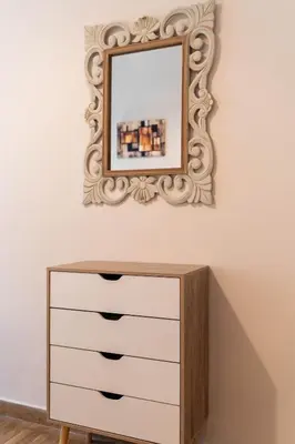 a mirror on a wall above a dresser at Rovertou Galli 3-5 by Athens Concept Residences in Athens