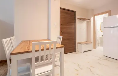 a kitchen with a table and chairs and a refrigerator at Rovertou Galli 3-5 by Athens Concept Residences in Athens