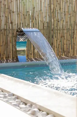 a water fountain in a swimming pool at Σπίτι με πισίνα δίπλα στο αεροδρόμιο. in Spáta