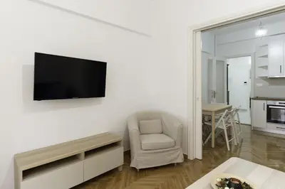 a living room with a tv on a white wall at Phaedrus Living: City Center Koukaki Flat in Athens