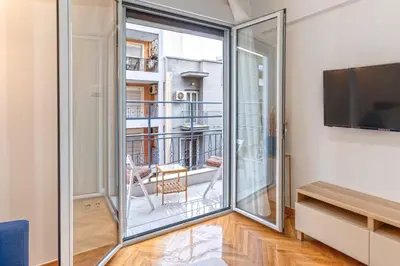a room with a sliding glass door leading to a balcony at Phaedrus Living: City Center Koukaki Flat in Athens