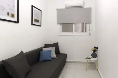 a living room with a couch and a window at Phaedrus Living: City Center Koukaki Flat in Athens