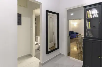 a hallway with a mirror and a living room at Phaedrus Living: City Center Koukaki Flat in Athens