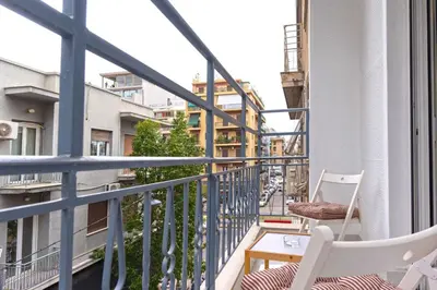 a balcony with two chairs and a table at Phaedrus Living: City Center Koukaki Flat in Athens