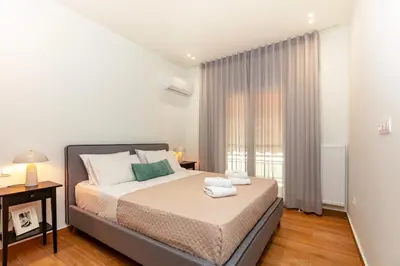 a bedroom with a bed and a window at Apartment near City Center in Athens