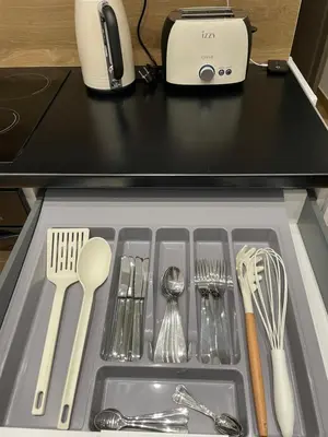 a drawer filled with silver utensils on a counter at Apartment near City Center in Athens