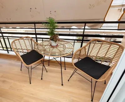 two chairs and a glass table on a balcony at Apartment near City Center in Athens