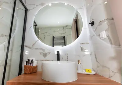 a bathroom with a white sink and a mirror at Apartment near City Center in Athens