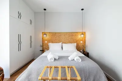 a bedroom with a bed with two benches on it at HeyDay Living South 8 in Athens