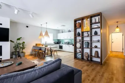 a living room and kitchen with a couch and a table at HeyDay Living South 8 in Athens