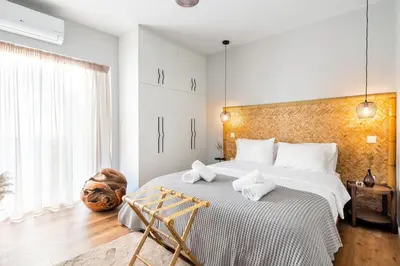 a bedroom with a large bed and a large window at HeyDay Living South 8 in Athens
