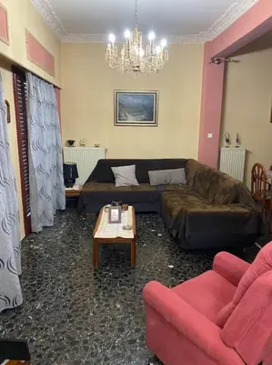 a living room with a couch and a table at House close to the port Piraeus and metro station in Piraeus