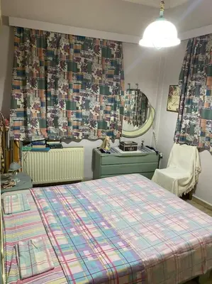 a bedroom with a bed and a sink and a mirror at House close to the port Piraeus and metro station in Piraeus