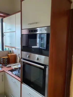 a kitchen with two ovens and a microwave at House close to the port Piraeus and metro station in Piraeus