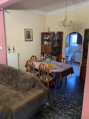 a living room with a table and a couch at House close to the port Piraeus and metro station in Piraeus