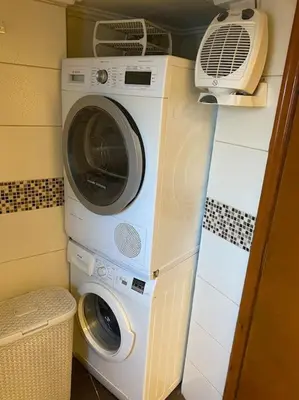 a washing machine and a dryer in a room at House close to the port Piraeus and metro station in Piraeus