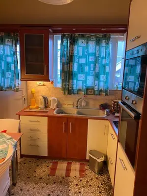 a kitchen with a sink and a stove top oven at House close to the port Piraeus and metro station in Piraeus
