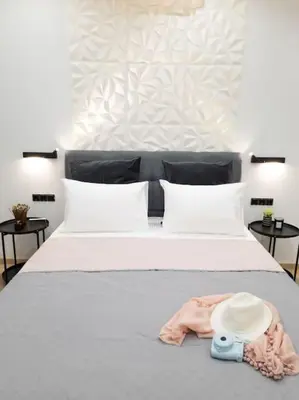 a bedroom with a bed with a hat on it at Azalea Suite - 5 min drive to Piraeus Port in Piraeus