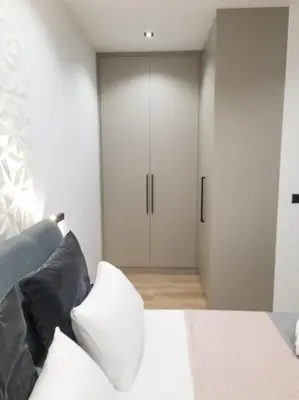 a bedroom with a bed and a closet at Azalea Suite - 5 min drive to Piraeus Port in Piraeus
