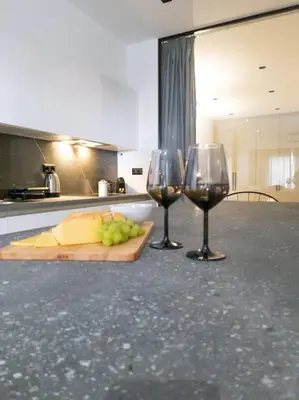 two glasses of wine and a cutting board with cheese and grapes at Azalea Suite - 5 min drive to Piraeus Port in Piraeus