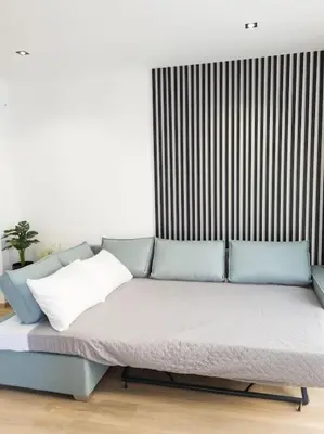 a bed with three pillows on it in a room at Azalea Suite - 5 min drive to Piraeus Port in Piraeus