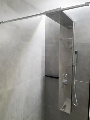 a shower with a glass door in a bathroom at Azalea Suite - 5 min drive to Piraeus Port in Piraeus