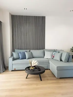 a living room with a couch and a table at Dahlia Suite - 5 min drive to Piraeus Port in Piraeus