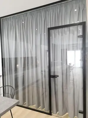 a room with a sliding glass door with a window at Dahlia Suite - 5 min drive to Piraeus Port in Piraeus