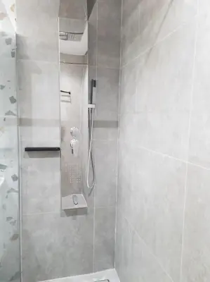 a bathroom with a shower with a glass door at Dahlia Suite - 5 min drive to Piraeus Port in Piraeus