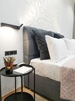a living room with a couch and a table at Dahlia Suite - 5 min drive to Piraeus Port in Piraeus