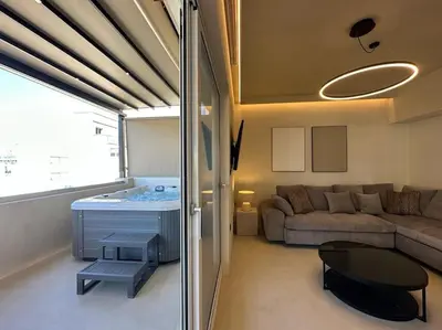 a living room with a couch and a table at BlueMotion - SkytouchSuite in Piraeus