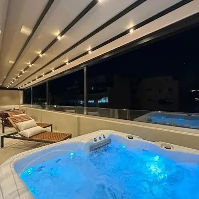 a large hot tub on the balcony of a building at BlueMotion - SkytouchSuite in Piraeus