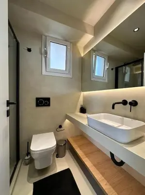 a bathroom with a sink and a toilet at BlueMotion - SkytouchSuite in Piraeus