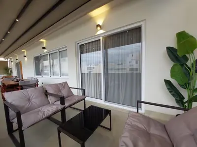 a living room with a couch and a table at BlueMotion - SkytouchSuite in Piraeus