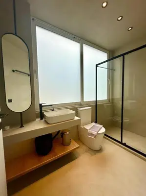 a bathroom with a toilet and a sink and a mirror at BlueMotion - SkytouchSuite in Piraeus