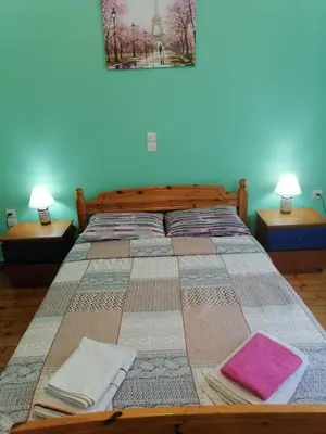 a bed with two pillows on top of it at Pilika4 in Athens