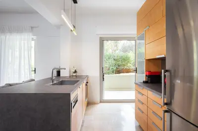 a kitchen with a sink and a refrigerator at Vouliagmeni Stylish Apartment in Athens