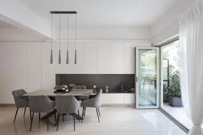 a dining room with a table and chairs at Vouliagmeni Stylish Apartment in Athens