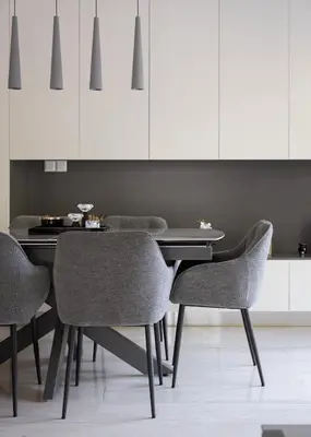 a dining room table with chairs and white cabinets at Vouliagmeni Stylish Apartment in Athens