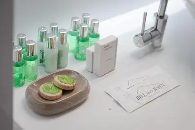 a table with a plate of cookies and glass bottles at Vouliagmeni Stylish Apartment in Athens