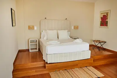a bedroom with a large white bed in a room at Athens Riviera Villa in Anavissos