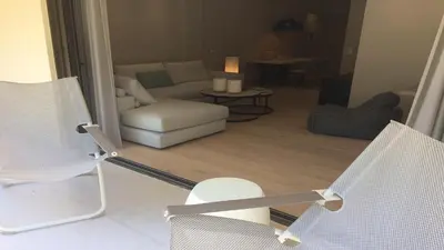 a living room with a couch and a chair at Athenian Riviera Exclusive flat , Athens Greece in Athens