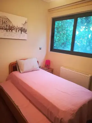a bed in a room with a large window at Mina’s Villa, 200m from the beach in Porto Rafti