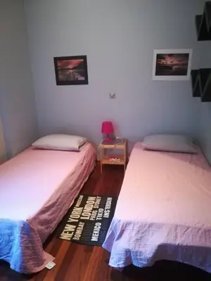a bedroom with two beds and a table with a lamp at Mina’s Villa, 200m from the beach in Porto Rafti