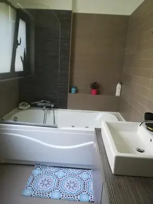 a bathroom with a white tub and a sink at Mina’s Villa, 200m from the beach in Porto Rafti
