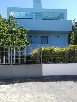 a fence in front of a house at Mina’s Villa, 200m from the beach in Porto Rafti